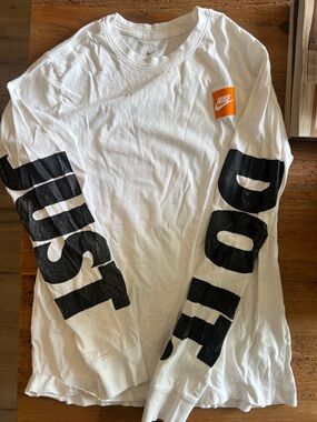 Nike White Long Sleeve Shirt with Black Sleeve Text and Orange Chest Logo